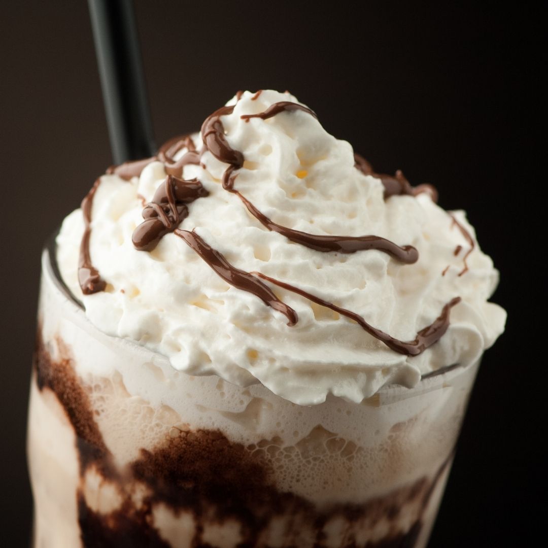 Chocolate milkshake with whipped cream and chocolate drizzle